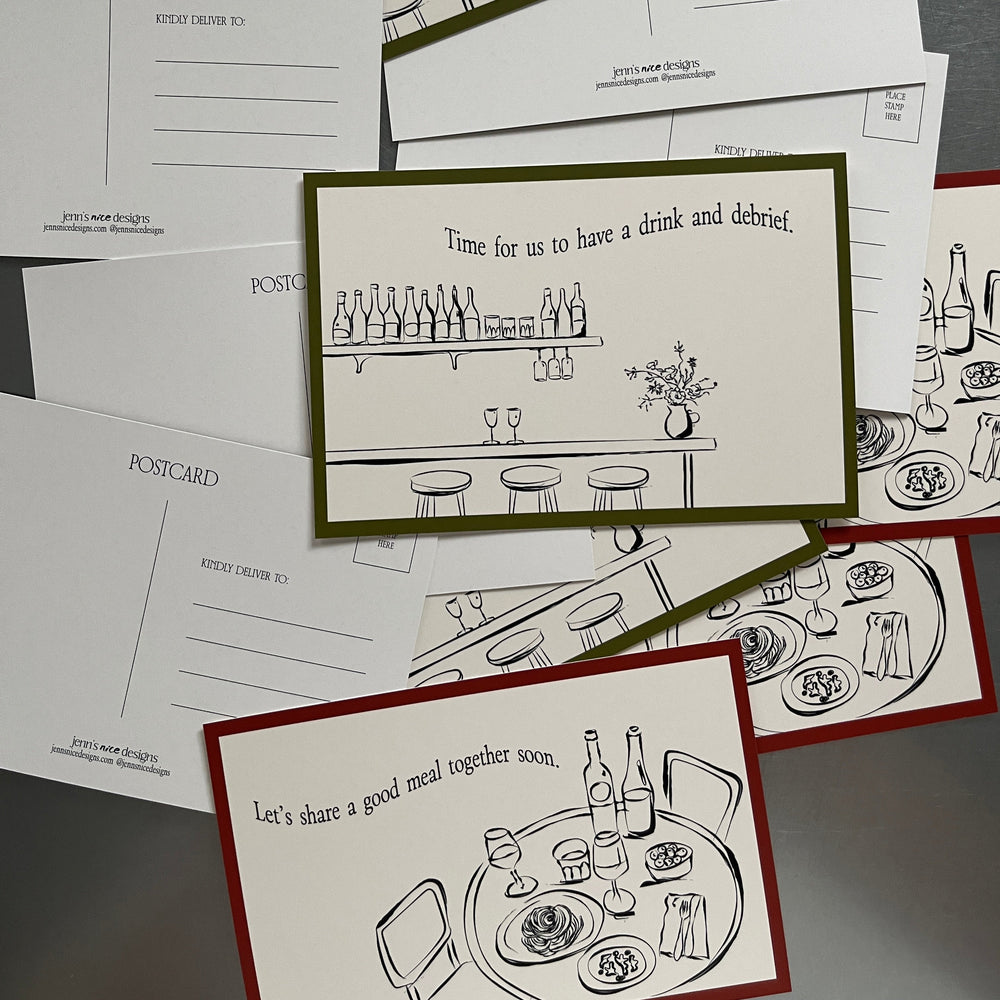 
                  
                    Collection of postcards with black line drawings on a gray surface
                  
                